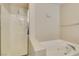 Bright bathroom featuring a walk-in shower and a jetted tub at 8407 Kettledrum St, Las Vegas, NV 89139