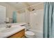 Bathroom with combined tub and shower, white fixtures, and updated vanity at 8407 Kettledrum St, Las Vegas, NV 89139