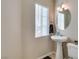 Clean half-bathroom with pedestal sink, decorative mirror, and modern fixtures at 8407 Kettledrum St, Las Vegas, NV 89139