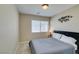 Cozy bedroom with a queen bed, large window, and modern decor at 8407 Kettledrum St, Las Vegas, NV 89139