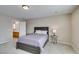 Comfortable bedroom with soft carpet, neutral walls, and a bathroom right off the bedroom at 8407 Kettledrum St, Las Vegas, NV 89139