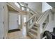 Bright entryway with tiled floors and staircase featuring glass railings leading upstairs at 8407 Kettledrum St, Las Vegas, NV 89139