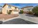 Front exterior showcasing a two-story home, two-car garage, and low maintenance landscaping at 8407 Kettledrum St, Las Vegas, NV 89139