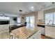 Kitchen with granite island, stainless steel appliances, and adjacent dining area with pool view at 8407 Kettledrum St, Las Vegas, NV 89139
