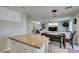 Open-concept kitchen and dining area with stairs and living room in the background at 8407 Kettledrum St, Las Vegas, NV 89139