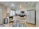 Bright kitchen with an island and seating, stainless steel appliances, and white cabinets at 8407 Kettledrum St, Las Vegas, NV 89139