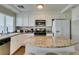Well-lit kitchen featuring granite countertops, stainless steel appliances, and ample cabinet space at 8407 Kettledrum St, Las Vegas, NV 89139