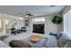 Bright living room featuring neutral colors, a fireplace, comfortable seating, and stylish decor at 8407 Kettledrum St, Las Vegas, NV 89139