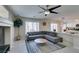 Cozy living room featuring a grey sectional sofa and views into the bright kitchen at 8407 Kettledrum St, Las Vegas, NV 89139