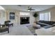 Bright living room featuring a ceiling fan, fireplace, and plush grey sectional sofa at 8407 Kettledrum St, Las Vegas, NV 89139