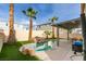 Backyard pool oasis with waterfall feature, covered patio, lush landscaping, and ample space for outdoor entertaining at 8407 Kettledrum St, Las Vegas, NV 89139