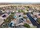 Community aerial view features swimming pools, desert landscaping, palm trees, solar panels, and neighborhood streets at 8412 Starstruck Ave, Las Vegas, NV 89143
