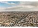 Expansive aerial view showcasing a neighborhood with proximity to the city skyline and distant mountains at 8412 Starstruck Ave, Las Vegas, NV 89143