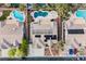 Aerial view of the house showing its solar panels, in-ground pool, backyard landscaping, and neighborhood at 8412 Starstruck Ave, Las Vegas, NV 89143