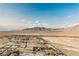 Panoramic aerial view showcases the community's desert landscape and mountain backdrop on a clear day with homes in view at 8412 Starstruck Ave, Las Vegas, NV 89143