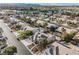 Aerial shot shows community homes with well-kept yards, solar panels, and a pool, all nestled in a desert environment at 8412 Starstruck Ave, Las Vegas, NV 89143