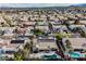 A landscape view highlights homes with backyard pools, solar panels, desert landscaping, and neighborhood streets at 8412 Starstruck Ave, Las Vegas, NV 89143