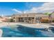 The backyard features a swimming pool, built in bar, covered patio and desert landscaping at 8412 Starstruck Ave, Las Vegas, NV 89143