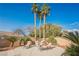 Enjoy outdoor living on this private patio with comfortable seating, desert landscaping, and palm tree views at 8412 Starstruck Ave, Las Vegas, NV 89143