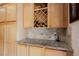 Built in bar area with a wine rack and granite countertops at 8412 Starstruck Ave, Las Vegas, NV 89143
