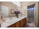 Bright bathroom featuring dual sinks, modern faucets, and tiled floors at 8412 Starstruck Ave, Las Vegas, NV 89143
