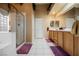 Bright bathroom featuring dual vanities, tiled floors, and a glass-enclosed shower at 8412 Starstruck Ave, Las Vegas, NV 89143