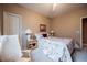 Bright bedroom featuring plush carpeting, a ceiling fan, and warm neutral tones, with a large window at 8412 Starstruck Ave, Las Vegas, NV 89143