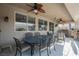 Relax on the covered patio with a dining area and outdoor seating, perfect for enjoying the backyard at 8412 Starstruck Ave, Las Vegas, NV 89143
