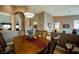 Open dining room boasts hardwood floors, decorative lighting, and an expansive dining table at 8412 Starstruck Ave, Las Vegas, NV 89143