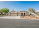 Charming single-story home featuring a three-car garage and well-manicured desert landscaping at 8412 Starstruck Ave, Las Vegas, NV 89143