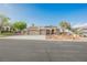 Charming single-story home featuring a three-car garage, desert landscaping, and a welcoming front porch at 8412 Starstruck Ave, Las Vegas, NV 89143