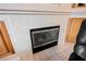 Close-up of a fireplace with tile surround and black metal grate at 8412 Starstruck Ave, Las Vegas, NV 89143