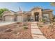 Charming single-story home with a three-car garage, desert landscaping, and welcoming front walkway at 8412 Starstruck Ave, Las Vegas, NV 89143