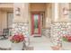 Inviting front porch with stone accents, decorative planters, and a stylish red entry door at 8412 Starstruck Ave, Las Vegas, NV 89143