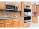 Modern kitchen features stainless steel appliances, granite countertops, and light wood cabinetry at 8412 Starstruck Ave, Las Vegas, NV 89143