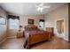 Main bedroom featuring hardwood floors, a ceiling fan, and large windows for natural light at 8412 Starstruck Ave, Las Vegas, NV 89143