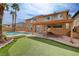 Expansive backyard showcasing a refreshing pool, green turf, and a covered patio, creating an outdoor haven at 8716 Castle Hill Ave, Las Vegas, NV 89129