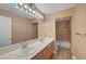 Bathroom features dual sinks, tile floors and a large mirror at 8716 Castle Hill Ave, Las Vegas, NV 89129