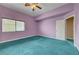 This bedroom features a ceiling fan, plush carpet, and ample closet space at 8716 Castle Hill Ave, Las Vegas, NV 89129
