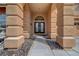 The front entrance with double doors is framed by stone columns at 8716 Castle Hill Ave, Las Vegas, NV 89129