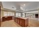 Spacious kitchen featuring an island with a cooktop and views to the backyard at 8716 Castle Hill Ave, Las Vegas, NV 89129