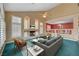 Bright living room with fireplace, ceiling fan, and plenty of natural light from large windows at 8716 Castle Hill Ave, Las Vegas, NV 89129