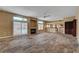 Open living room boasts a cozy fireplace, plenty of natural light, and modern flooring at 8716 Castle Hill Ave, Las Vegas, NV 89129
