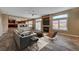 Open-concept living room showcases a fireplace, ceiling fan, and flows seamlessly into the kitchen at 8716 Castle Hill Ave, Las Vegas, NV 89129