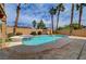 Sparkling pool with integrated spa, surrounded by lush landscaping and a stone patio, creating a serene oasis at 8716 Castle Hill Ave, Las Vegas, NV 89129
