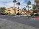 Inviting building exterior showcases well-maintained landscaping, ample parking, and mature palm trees at 900 Heavenly Hills Ct # 219, Las Vegas, NV 89145
