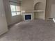 A brightly lit living room features a fireplace, neutral walls, carpet and a large window at 900 Heavenly Hills Ct # 219, Las Vegas, NV 89145