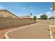 A quaint backyard features privacy walls and desert-friendly gravel landscaping at 9051 Sandy Slate Way, Las Vegas, NV 89123