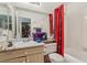 Bathroom featuring a vanity, mirror, toilet, and shower with a red curtain at 9051 Sandy Slate Way, Las Vegas, NV 89123