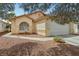 Charming single-story home with a well-maintained lawn and a spacious two-car garage at 9051 Sandy Slate Way, Las Vegas, NV 89123